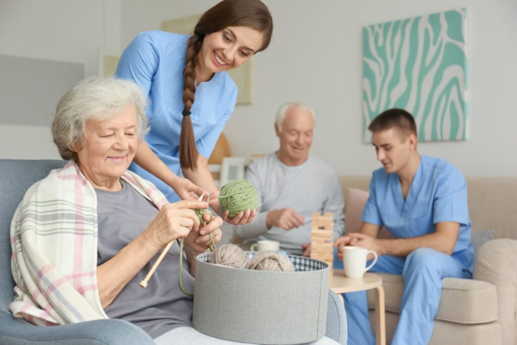 Seniors participating in social activities with caregivers in a residential care home