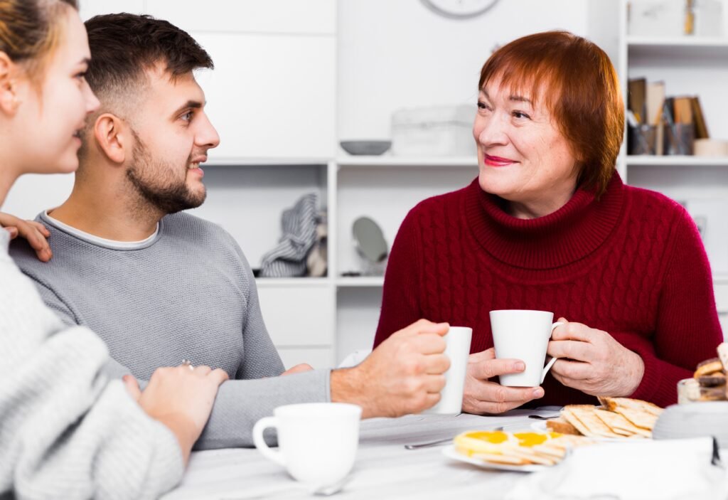 Adult children having a warm conversation with an older parent about future planning and family support