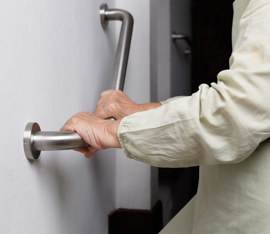 Senior using grab bars at home to improve safety and maintain independence