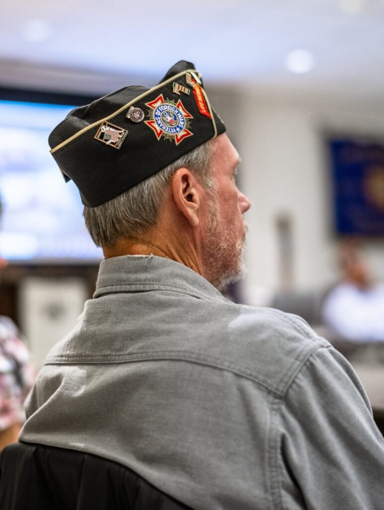 Michigan veteran wearing service cap learning about VA Aid and Attendance eligibility for senior care benefits