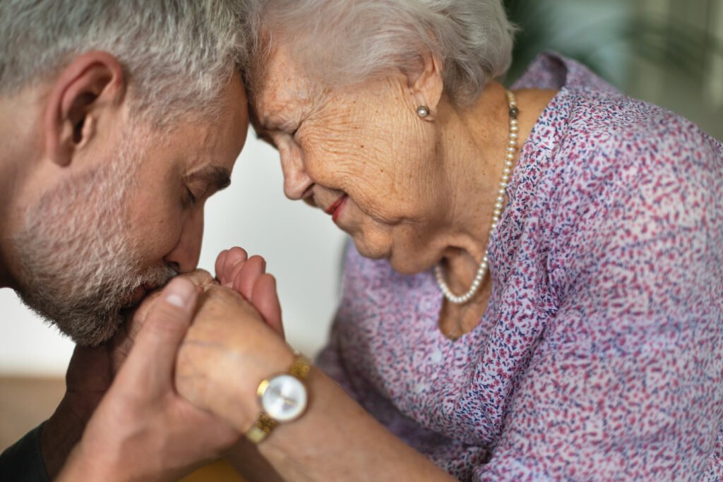 caregiver showing love and emotional support to elderly parent