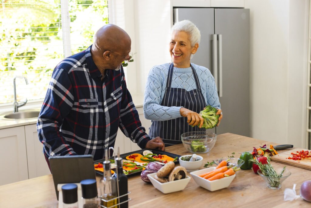 Elderly couple preparing healthy meal together for Parkinson’s care at home