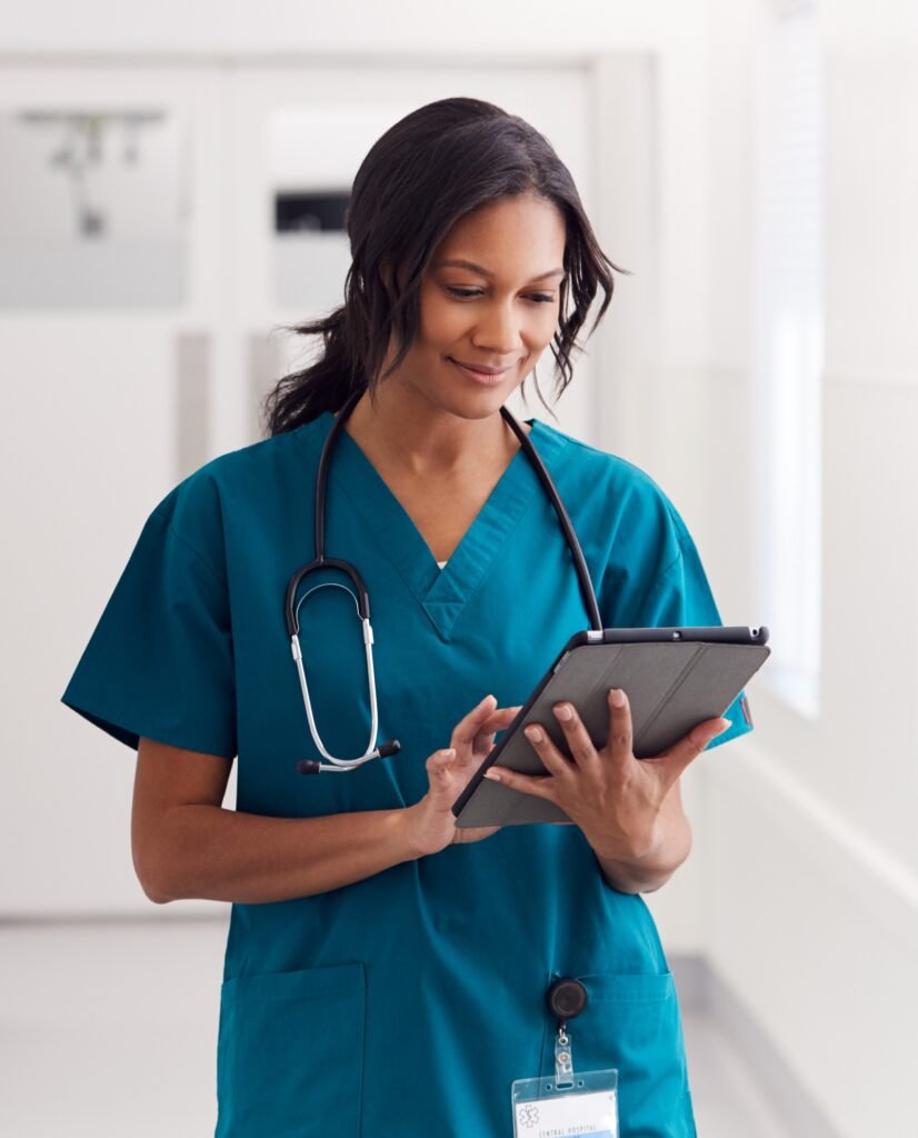 Healthcare professional reviewing patient information on a digital tablet in a healthcare setting