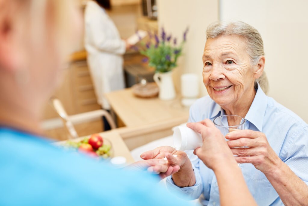 Senior woman receiving medication assistance and daily nursing support in a nursing home setting