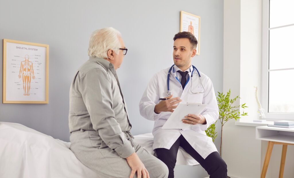 Why men delay medical care as an older man speaks with a doctor during a preventive healthcare visit
