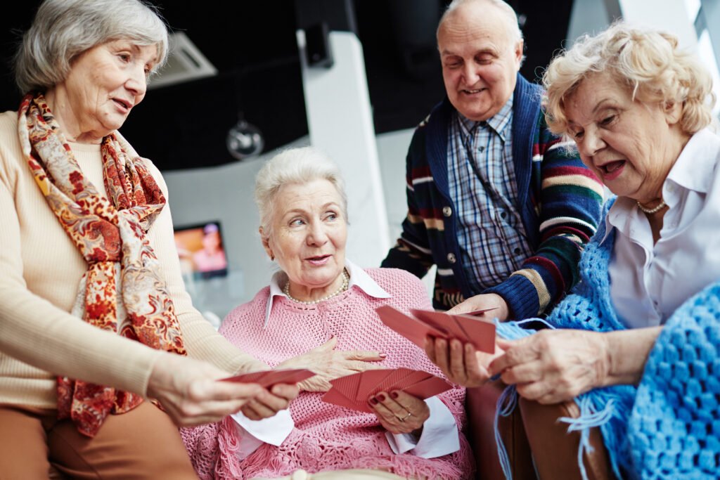 Older adults participating in a social card game activity at an assisted living community