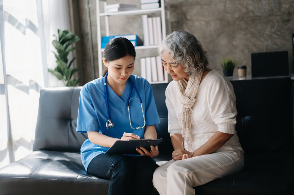 Nurse reviewing a home health care plan with an older adult during an in-home visit.