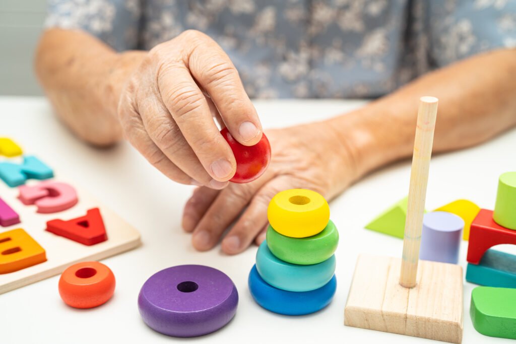 Older adult participating in a cognitive activity during a memory care program at a senior care community