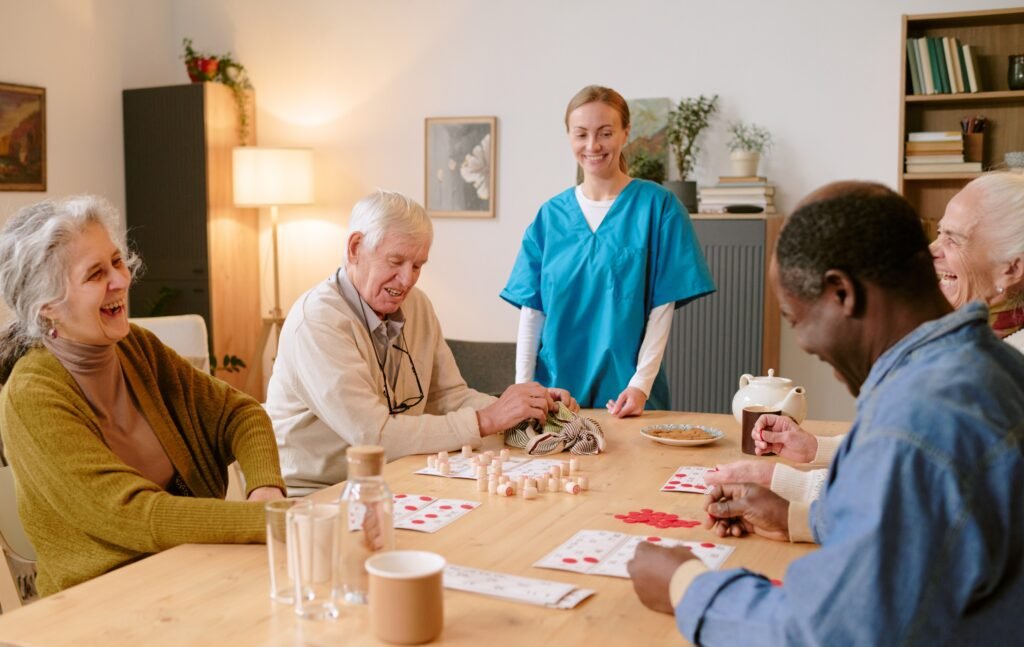 Older adults enjoying a group activity in a senior care community while a caregiver provides support