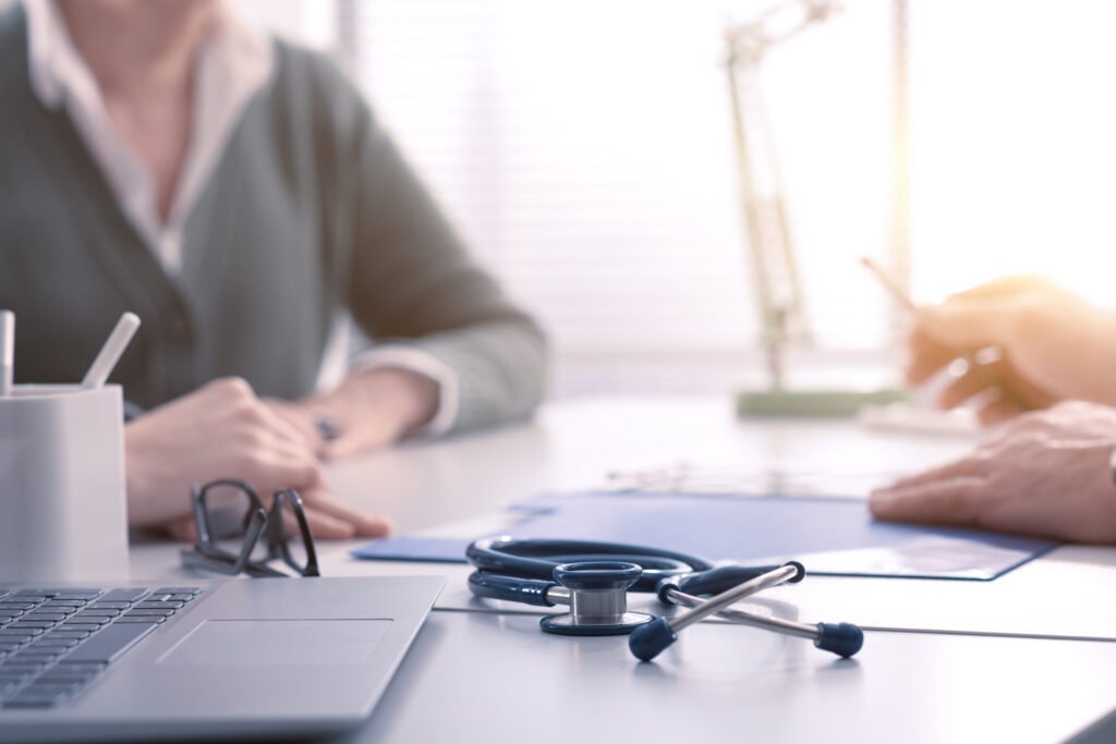 Healthcare professional discussing symptoms, concerns, and care options with a patient during a medical appointment.