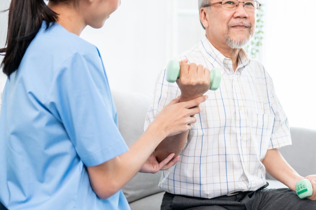 Physical therapist helping an older adult with dementia perform strength exercises to improve mobility and balance.