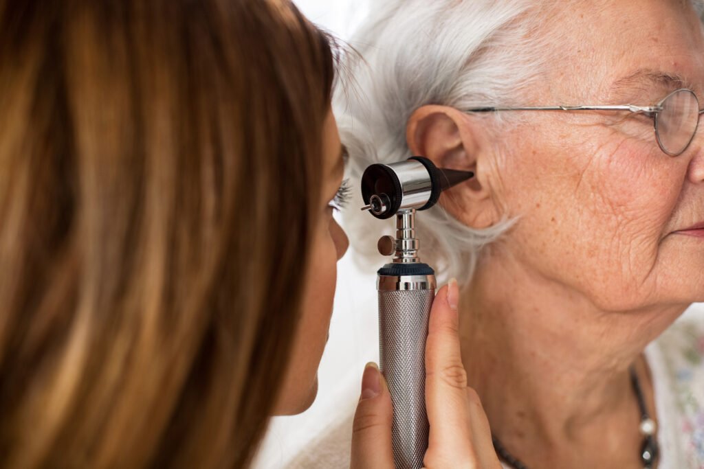 Older adult having a hearing exam as part of addressing hearing loss and dementia risk