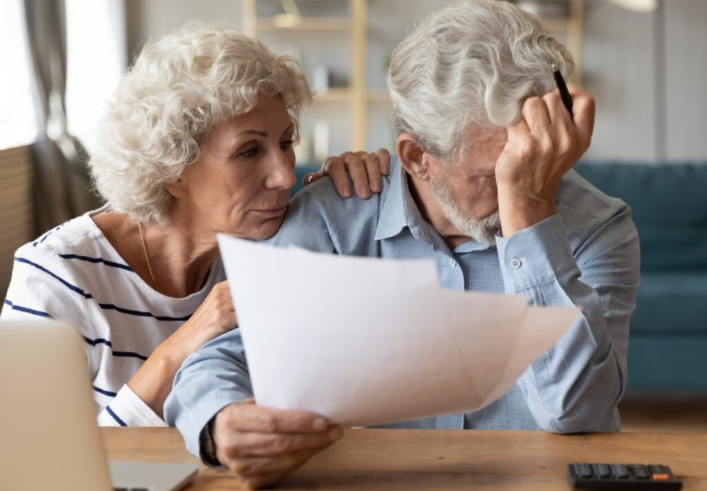 Senior couple reviewing bills and the hidden costs of home care