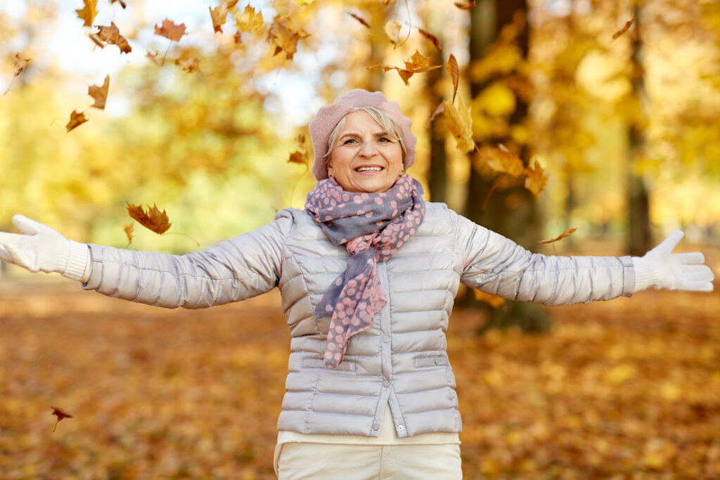 Older woman staying active outdoors in autumn for fall safety for seniors